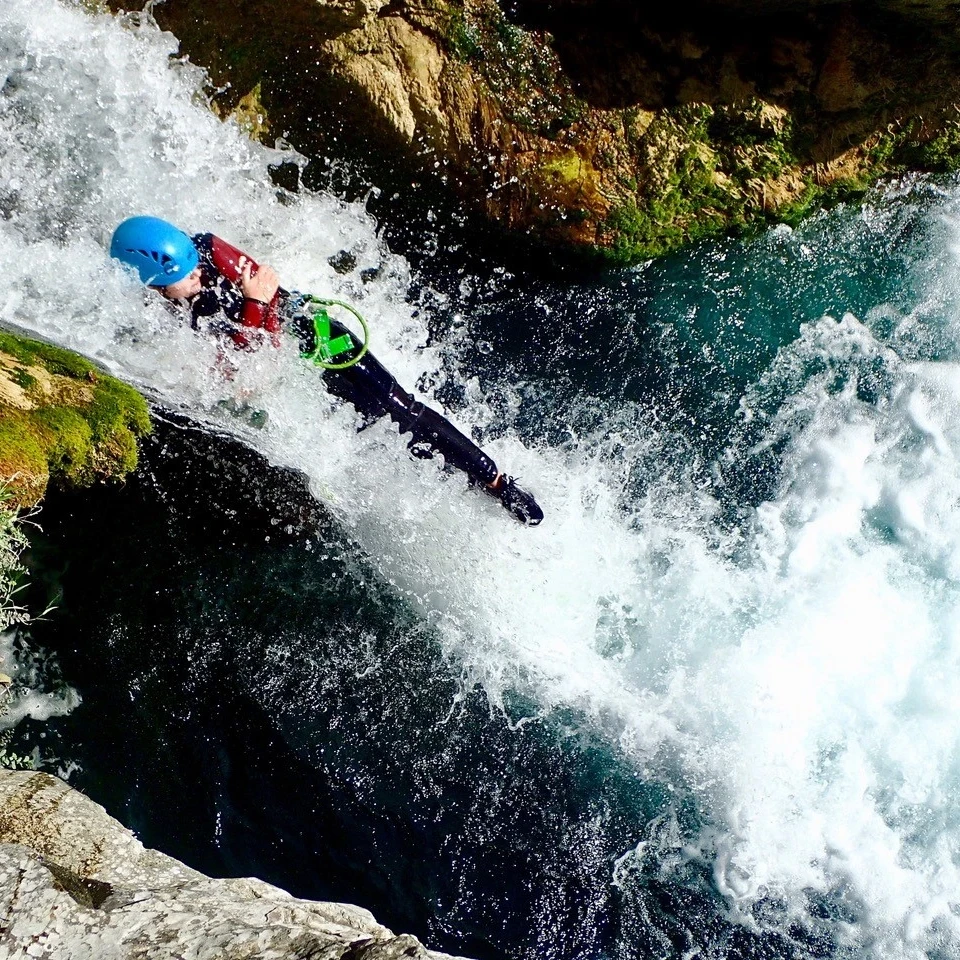 Natural rock slide during a refreshing canyoning experience in southern France